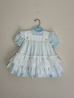 Vintage 1980's light baby blue dress with white eyelet lace pinafore. Maker- Golden Age  Size- tag 24 months Length- 16 1/2 in Width- 12 in ptp Excellent vintage condition. Vintage Cotton Baptism Dress For Spring, Vintage Baptism Dress With Lace Trim For Spring, Blue Coquette, Baby Blue Dress, Baby Blue Dresses, White Eyelet, Fort Collins, Eyelet Lace, Sewing Project