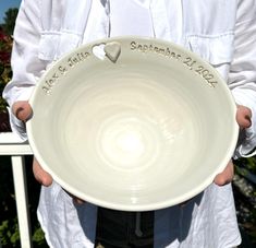 a person holding a white plate with a heart on it