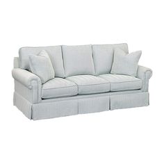 a white couch with four pillows on it