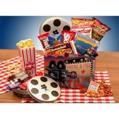 a movie themed gift basket with popcorn, movies and other snacks on a checkered tablecloth