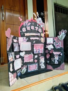 a black and pink bulletin board with pictures on it