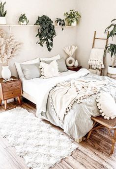 a bedroom with plants on the wall and a bed in the middle, along with white rugs