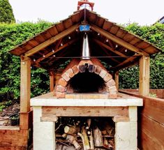 an outdoor pizza oven in the middle of a garden