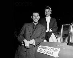 an old photo of two people standing next to a car with the word annn carson on it