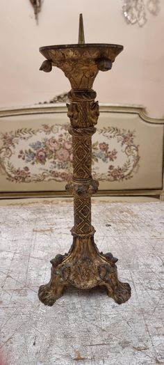 an ornate wooden candle holder in the middle of a room