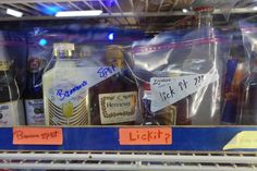 bottles of liquor are on display in a grocery store's glass case for sale