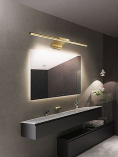 a bathroom with a sink, mirror and lights on the wall next to each other