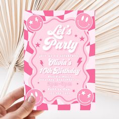 a person holding up a pink birthday card