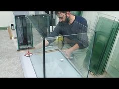 a man sitting on top of a glass floor