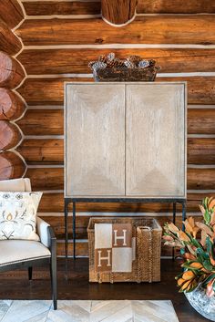 a living room with wood paneling and furniture on the floor next to a plant