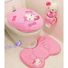 a pink hello kitty toilet seat cover and rug