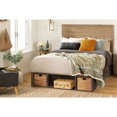 a bed with baskets underneath it in a room