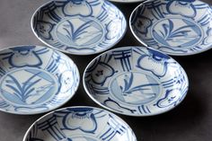 four blue and white bowls with designs on them