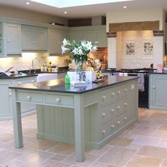 a large kitchen with an island in the middle