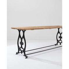 an iron and wood console table with wheels on the legs, against a white background