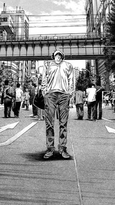 a black and white photo of a man standing on the street