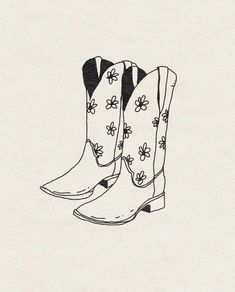 a pair of cowboy boots with flowers on them