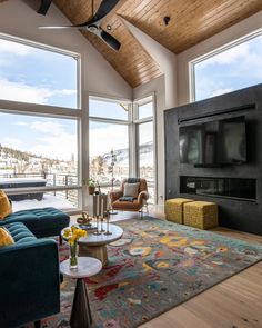 a living room filled with furniture and a flat screen tv on top of a wall