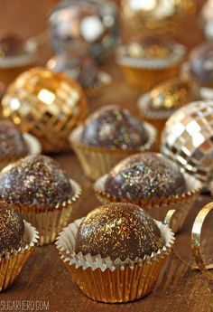 there are many different types of chocolates on the table with gold foil around them