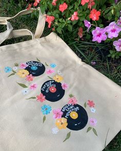 a tote bag with flowers painted on it