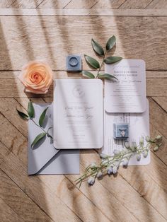 the wedding stationery is laid out on the floor