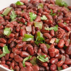 a white bowl filled with red beans and cilantro