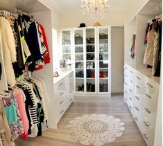 an image of a closet with clothes on the shelves