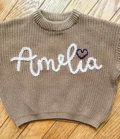 a sweater with the word ambella written on it and a heart in the middle