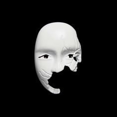 a white mask with black eyes and mouth