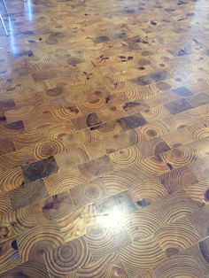 the floor is made from wood and has circles on it, as well as metal bars