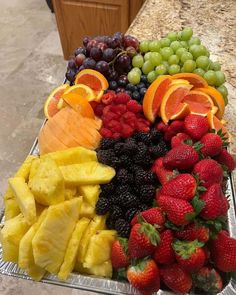 a platter filled with lots of different types of fruit on top of a counter