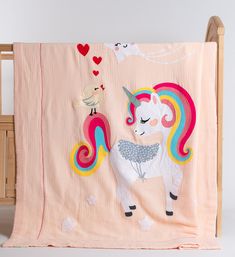 a pink blanket with a unicorn on it