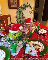 the table is set for christmas dinner with santa hats and other holiday decorations on it