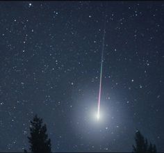 an object is seen in the night sky with stars and trees around it as well