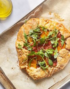 a pizza sitting on top of a pan covered in veggies