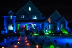 a house is lit up with blue and green lights