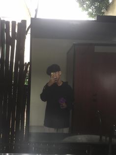 a man taking a selfie in front of a mirror