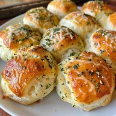 a white plate topped with rolls covered in cheese