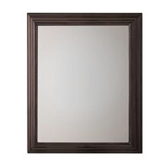 a brown framed mirror on a white wall