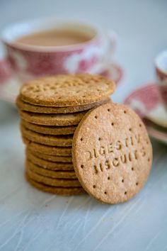 a stack of cookies next to a cup of coffee