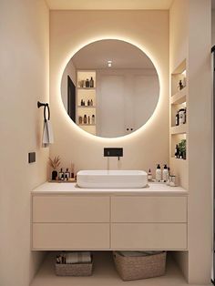 a bathroom with a large round mirror above the sink and shelves on the wall behind it