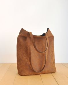 "This tote bag is made of high quality vegan leather in brown. It is soft and lightweight but durable. It has a rustic, distressed look. It has two interior pockets. It has a slouchy silhouette and plenty of room for your daily needs. Measurements: 41 x 31 x 14 cm IMPORTANT! Your orders between 7-25 August will be shipped on August 28. Delivery takes 2-5 days to the US, Canada, Australia and Europe; in 3-7 days to rest of the world after shipping. For other color options you can check \"Totes\" Madewell Tote, Yellow Tote Bag, Vegan Tote Bag, Red Tote Bag, Brown Tote Bag, Purple Bag, Vegan Handbags, Vegan Leather Tote, Red Tote