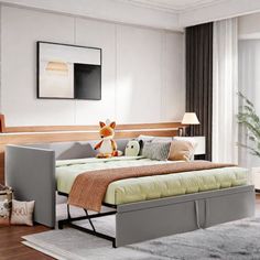 a modern daybed with storage underneath it in a living room next to a large window