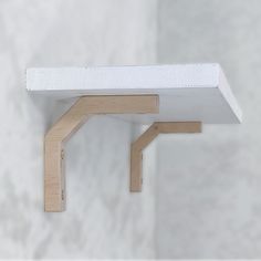 a close up of a shelf with a white wall in the background and wood trim around it