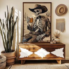 a skeleton in a cowboy hat is holding a glass of beer while sitting on a dresser