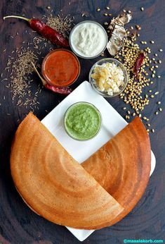 an assortment of dips and condiments on a plate