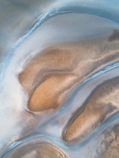 sand and water are seen in this aerial view