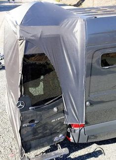 the back end of a vehicle with a tent on it