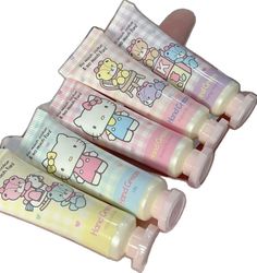 three tubes with hello kitty designs on them