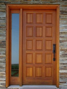 a close up of a wooden door on a stone building